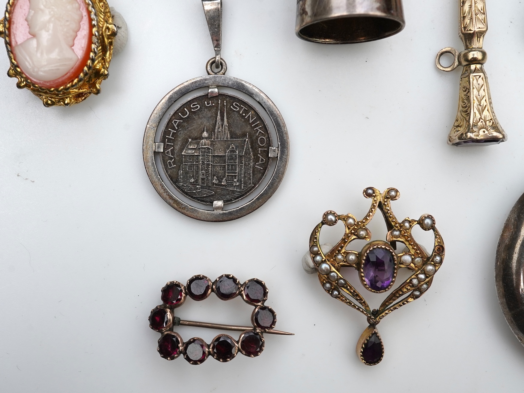 A small group of assorted collectables and jewellery including a Dunhill lighter, 64mm, a George V silver and enamel small compact, silver thimble, two Victorian garnet set brooches, an Edwardian 9ct, amethyst and seed p